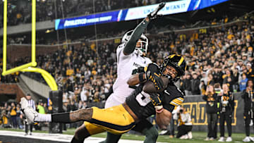 Nov 22, 2025; Iowa City, Iowa, USA; Iowa Hawkeyes wide receiver Jacob Gill (5) catches the game tying touchdown as Michigan State Spartans defensive back Dontavius Nash (28) defends during the fourth quarter at Kinnick Stadium. Mandatory Credit: Jeffrey Becker-Imagn Images