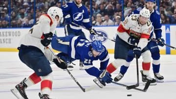 Lightning's Brayden Point and Panthers' Carter Verhaeghe battle for puck