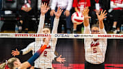 Oct 25, 2024; Lincoln, NE, USA; Nebraska Cornhuskers setter Bergen Reilly (2) and middle blocker Rebekah Allick (5) block Illinois Fighting Illini outside hitter Averie Hernandez (8) during the third set at Bob Devaney Sports Center. 