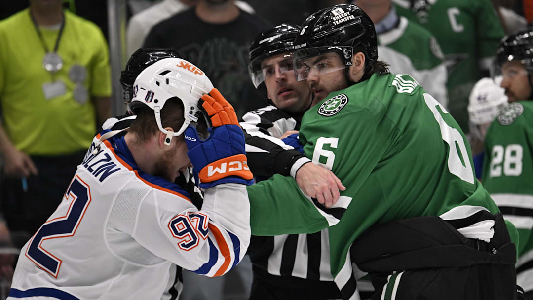 May 23, 2025; Dallas, Texas, USA; Edmonton Oilers right wing Vasily Podkolzin (92) and Dallas Stars defenseman Lian Bichsel (6) fight in the third period for game two of the Western Conference Final of the 2025 Stanley Cup Playoffs at American Airlines Center. Mandatory Credit: Jerome Miron-Imagn Images