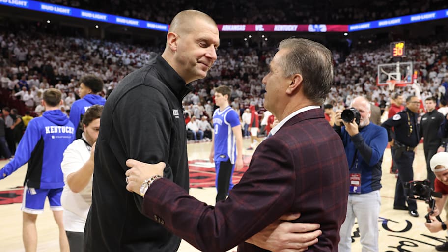 Kentucky Wildcats head coach Mark Pope shakes hands with Arkansas Razorbacks head coach John Calipari.