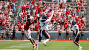 Sep 6, 2025; Raleigh, North Carolina, USA; Virginia Cavaliers wide receiver Jahmal Edrine (7) catches the pass, past North Carolina State Wolfpack cornerback Jamel Johnson (21) during the second half of the game at Carter-Finley Stadium. Mandatory Credit: Jaylynn Nash-Imagn Images