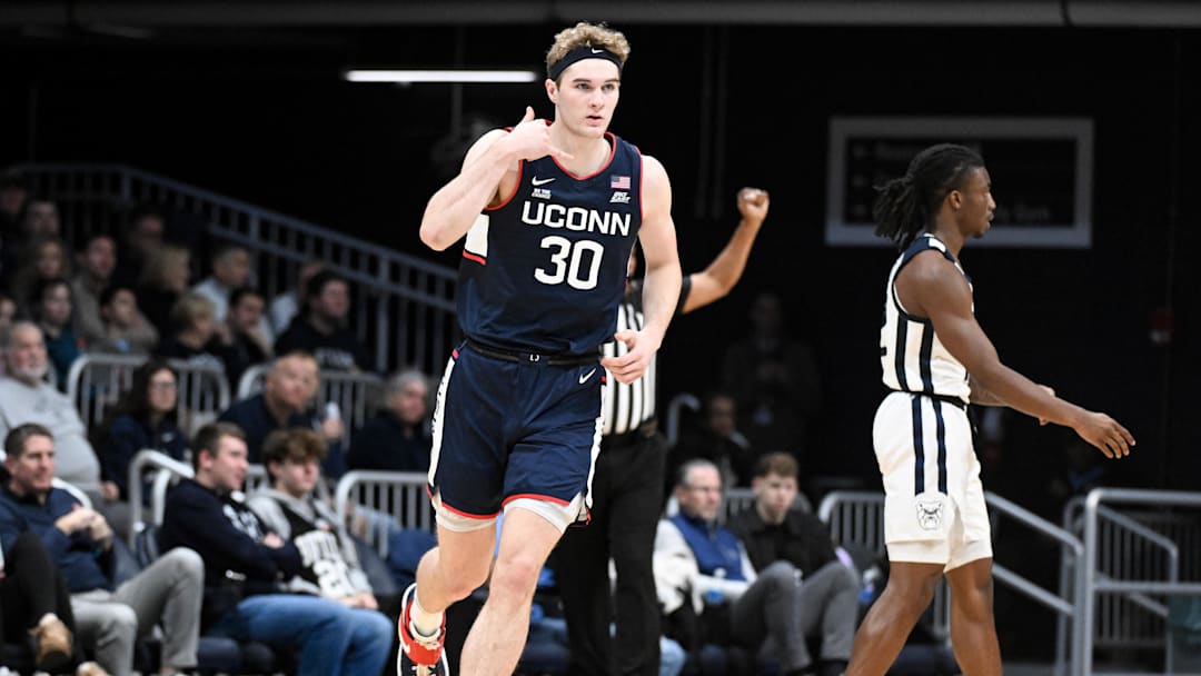 Dec 21, 2024; Indianapolis, Indiana, USA; Connecticut Huskies forward Liam McNeeley (30) celebrates after making a three point basket during the first half against the Butler Bulldogs at Hinkle Fieldhouse. Mandatory Credit: Robert Goddin-Imagn Images