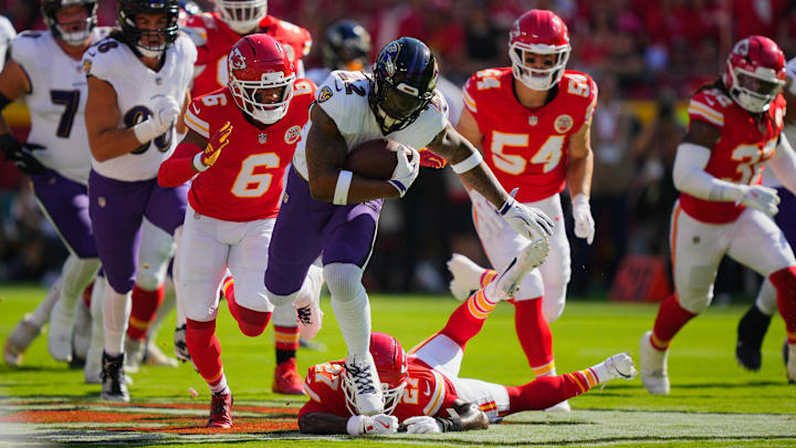 Sep 28, 2025; Kansas City, Missouri, USA; Baltimore Ravens running back Derrick Henry (22) rushes as Kansas City Chiefs safety Chamarri Conner (27) and Kansas City Chiefs safety Bryan Cook (6) defend during the first half at GEHA Field at Arrowhead Stadium. Mandatory Credit: Jay Biggerstaff-Imagn Images Sep 28, 2025; Kansas City, Missouri, USA; Baltimore Ravens running back Derrick Henry (22) rushes as Kansas City Chiefs safety Chamarri Conner (27) and Kansas City Chiefs safety Bryan Cook (6) defend during the first half at GEHA Field at Arrowhead Stadium. Mandatory Credit: Jay Biggerstaff-Imagn Images