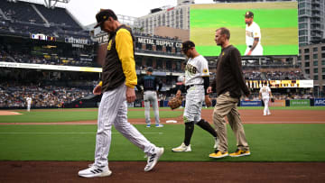 May 7, 2022; San Diego, California, USA; San Diego Padres right fielder Matt Beaty (center) leaves the game after an injury sustained during the second inning against the Miami Marlins at Petco Park. Mandatory Credit: Orlando Ramirez-USA TODAY Sports