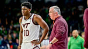 Feb 8, 2025; South Bend, Indiana, USA; Virginia Tech Hokies head coach Mike Young talks to guard Tyler Johnson (10) in the second half against the Notre Dame Fighting Irish at the Purcell Pavilion. Mandatory Credit: Matt Cashore-Imagn Images