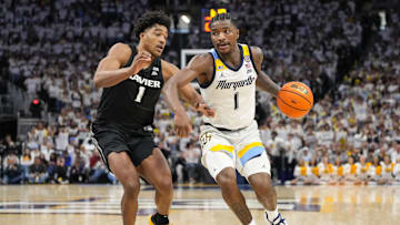 Jan 18, 2025; Milwaukee, Wisconsin, USA;  Marquette Golden Eagles guard Kam Jones (1) drives for the basket against Xavier Musketeers guard Marcus Foster (1) during the second half at Fiserv Forum. Mandatory Credit: Jeff Hanisch-Imagn Images