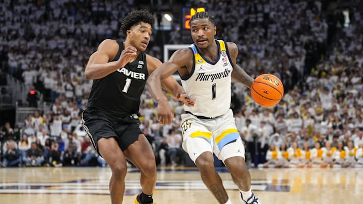 Jan 18, 2025; Milwaukee, Wisconsin, USA;  Marquette Golden Eagles guard Kam Jones (1) drives for the basket against Xavier Musketeers guard Marcus Foster (1) during the second half at Fiserv Forum. Mandatory Credit: Jeff Hanisch-Imagn Images