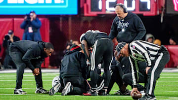 Nov 1, 2025; Lincoln, Nebraska, USA; Nebraska Cornhuskers head coach Matt Rhule and running back Emmett Johnson (21) gather around quarterback Dylan Raiola (15) after he was injured.