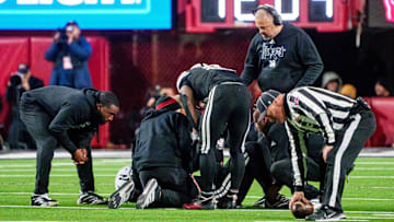 Nov 1, 2025; Lincoln, Nebraska, USA; Nebraska Cornhuskers head coach Matt Rhule and running back Emmett Johnson (21) gather around quarterback Dylan Raiola (15) after he was injured during the third quarter against the Southern California Trojans at Memorial Stadium. Mandatory Credit: Dylan Widger-Imagn Images