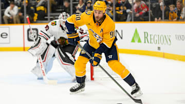 Jan 16, 2025; Nashville, Tennessee, USA;  Nashville Predators center Ryan O'Reilly (90) skates with the puck against the Chicago Blackhawks during the first period at Bridgestone Arena. Mandatory Credit: Steve Roberts-Imagn Images
