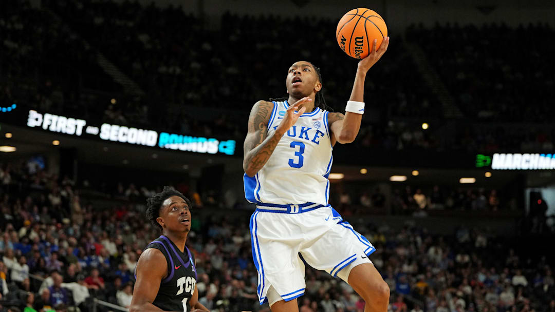 Mar 21, 2026; Greenville, SC, USA; Duke Blue Devils guard Isaiah Evans (3) drives to the basket against Texas Christian University Horned Frogs guard Jayden Pierre (1) during the first half during a second round game of the men's 2026 NCAA Tournament at Bon Secours Wellness Arena. Mandatory Credit: Bob Donnan-Imagn Images