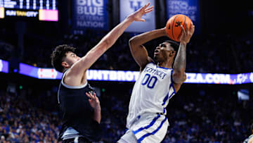 Oct 30, 2025; Lexington, KY, USA; Kentucky Wildcats guard Otega Oweh (00) shoots the ball against Georgetown Hoyas center Julius Halaifonua (11) during the second half at Rupp Arena at Central Bank Center. Mandatory Credit: Jordan Prather-Imagn Images