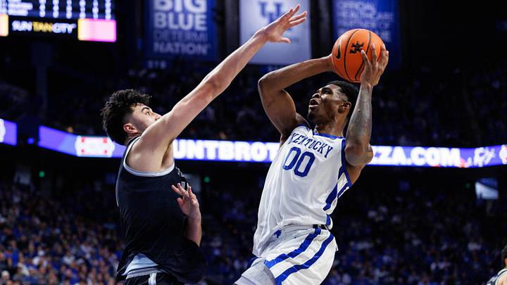 Oct 30, 2025; Lexington, KY, USA; Kentucky Wildcats guard Otega Oweh (00) shoots the ball against Georgetown Hoyas center Julius Halaifonua (11) during the second half at Rupp Arena at Central Bank Center. Mandatory Credit: Jordan Prather-Imagn Images