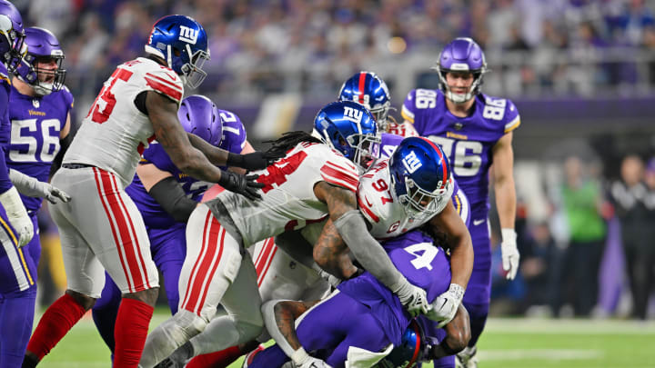 Jan 15, 2023; Minneapolis, Minnesota, USA; Minnesota Vikings running back Dalvin Cook (4) is tackled by New York Giants defensive tackle Dexter Lawrence (97) and defensive end Leonard Williams (bottom) during the second quarter of a wild card game at U.S. Bank Stadium.  