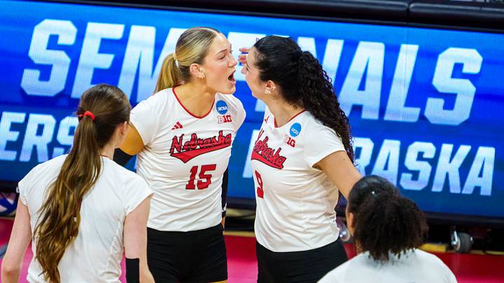 Dec 12, 2025; Lincoln, NE, USA; Nebraska Cornhuskers middle blocker Andi Jackson (15) and opposite hitter Virginia Adriano (9) react after a point against the Kansas Jayhawks during the second set at Bob Devaney Sports Center. Mandatory Credit: Dylan Widger-Imagn Images Dec 12, 2025; Lincoln, NE, USA; Nebraska Cornhuskers middle blocker Andi Jackson (15) and opposite hitter Virginia Adriano (9) react after a point against the Kansas Jayhawks during the second set at Bob Devaney Sports Center. Mandatory Credit: Dylan Widger-Imagn Images