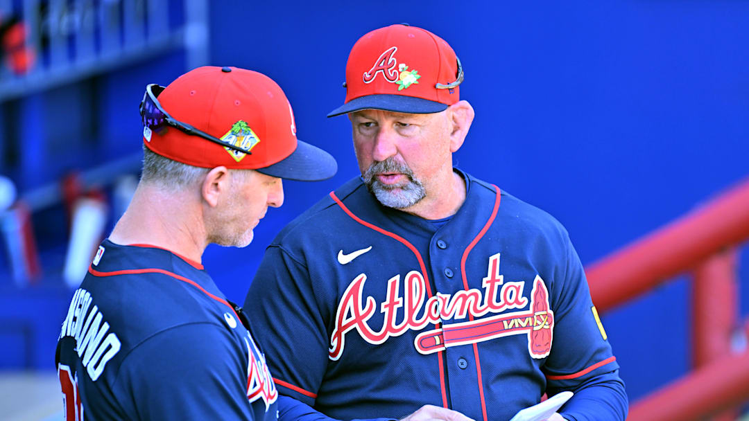 Walt Weiss (4) talks with bench coach Tony Mansolino (89) before the start of the game against the Pittsburgh Pirates.