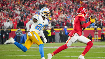 Dec 8, 2024; Kansas City, Missouri, USA; Kansas City Chiefs wide receiver Xavier Worthy (1) runs the ball as Los Angeles Chargers cornerback Cam Hart (20) defends during the first half at GEHA Field at Arrowhead Stadium. Mandatory Credit: Denny Medley-Imagn Images
