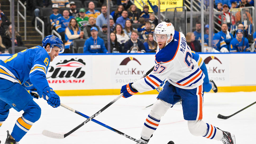 Mar 13, 2026; St. Louis, Missouri, USA; Edmonton Oilers center Connor McDavid (97) shoots as St. Louis Blues defenseman Philip Broberg (6) defends during the first period at Enterprise Center. Mandatory Credit: Jeff Curry-Imagn Images