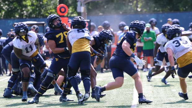 West Virginia University running back CJ Donaldson busts through the middle of the line of scrimmage during fall camp (2024).