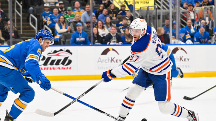 Mar 13, 2026; St. Louis, Missouri, USA; Edmonton Oilers center Connor McDavid (97) shoots as St. Louis Blues defenseman Philip Broberg (6) defends during the first period at Enterprise Center. Mandatory Credit: Jeff Curry-Imagn Images