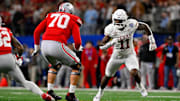 Jan 10, 2025; Arlington, TX, USA; Ohio State Buckeyes offensive lineman Josh Fryar (70) and Texas Longhorns linebacker Colin Simmons (11) in action during the game between the Texas Longhorns and the Ohio State Buckeyes at AT&T Stadium. Mandatory Credit: Jerome Miron-Imagn Images