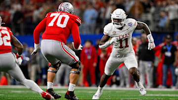 Jan 10, 2025; Arlington, TX, USA; Ohio State Buckeyes offensive lineman Josh Fryar (70) and Texas Longhorns linebacker Colin Simmons (11) in action during the game between the Texas Longhorns and the Ohio State Buckeyes at AT&T Stadium. Mandatory Credit: Jerome Miron-Imagn Images