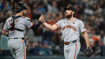 Aug 23, 2024; Seattle, Washington, USA; San Francisco Giants relief pitcher Ryan Walker (74), right, and catcher Curt Casali (2) celebrate after a game Mariners at T-Mobile Park.