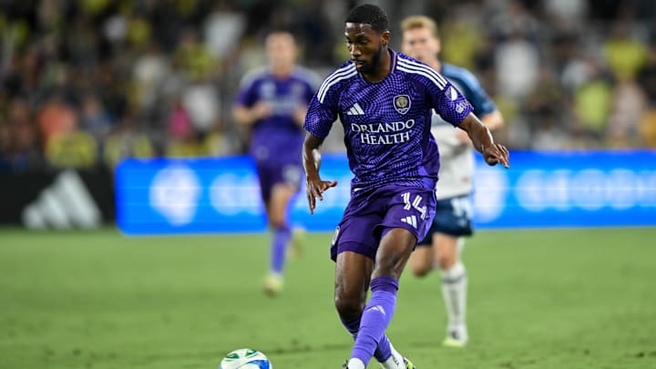 Aug 23, 2025; Nashville, Tennessee, USA;  Orlando City forward Tyrese Spicer (14) dribbles the ball against the Nashville SC during the first half at Geodis Park. Mandatory Credit: Steve Roberts-Imagn Images