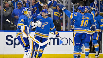 Mar 16, 2024; St. Louis, Missouri, USA;  St. Louis Blues center Jordan Kyrou (25) celebrates with goaltender Jordan Binnington (50) after the Blues defeated the Minnesota Wild in shoot outs at Enterprise Center. Mandatory Credit: Jeff Curry-Imagn Images