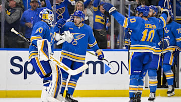 Mar 16, 2024; St. Louis, Missouri, USA;  St. Louis Blues center Jordan Kyrou (25) celebrates with goaltender Jordan Binnington (50) after the Blues defeated the Minnesota Wild in shoot outs at Enterprise Center. Mandatory Credit: Jeff Curry-Imagn Images