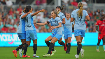 Jul 20, 2024; Kansas City, Missouri, USA; Houston Dash midfielder Barbara Olivieri (15) and teammates celebrate after a goal during the first half against the Kansas City Current at CPKC Stadium. Mandatory Credit: Jay Biggerstaff-USA TODAY Sports