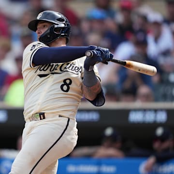 Aug 11, 2024; Minneapolis, Minnesota, USA; Minnesota Twins catcher Christian Vazquez (8) hits a single during the ninth inning against the Cleveland Guardians at Target Field.