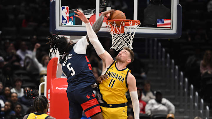 Feb 20, 2026; Washington, District of Columbia, USA; Washington Wizards guard Jamir Watkins (5) dunks over Indiana Pacers center Micah Potter (11) during the fourth quarter at Capital One Arena. Mandatory Credit: Rafael Suanes-Imagn Images