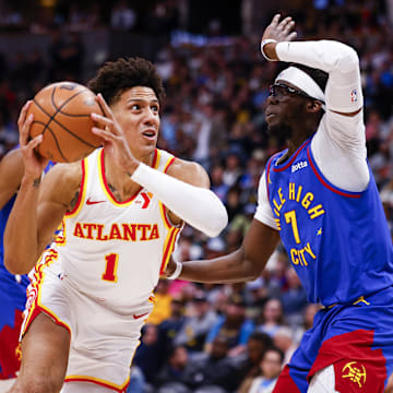 Apr 6, 2024; Denver, Colorado, USA; Atlanta Hawks forward Jalen Johnson (1) drives to the basket past Denver Nuggets guard Reggie Jackson (7) in the second half at Ball Arena. Mandatory Credit: Michael Ciaglo-Imagn Images