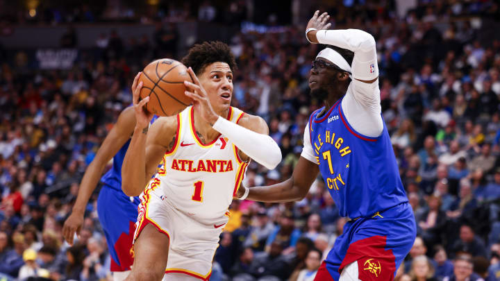 Apr 6, 2024; Denver, Colorado, USA; Atlanta Hawks forward Jalen Johnson (1) drives to the basket past Denver Nuggets guard Reggie Jackson (7) in the second half at Ball Arena. Mandatory Credit: Michael Ciaglo-USA TODAY Sports