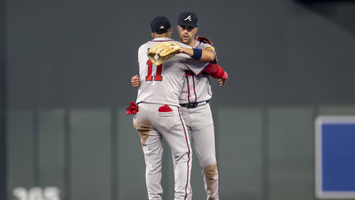 Aug 26, 2024; Minneapolis, Minnesota, USA; Atlanta Braves shortstop Orlando Arcia (11) and second baseman Whit Merrifield (15) celebrate after defeating the Minnesota Twins at Target Field. Mandatory Credit: Jesse Johnson-USA TODAY Sports