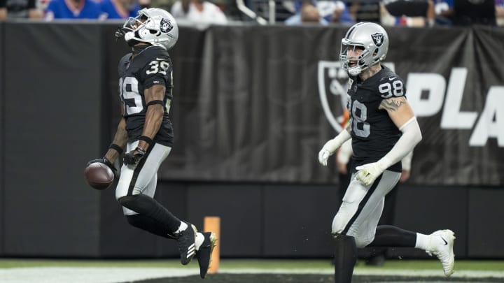 November 5, 2023; Paradise, Nevada, USA; Las Vegas Raiders cornerback Nate Hobbs (39) and defensive end Maxx Crosby (98) celebrate after an interception by Hobbs against the New York Giants during the second quarter at Allegiant Stadium. Mandatory Credit: Kyle Terada-USA TODAY Sports