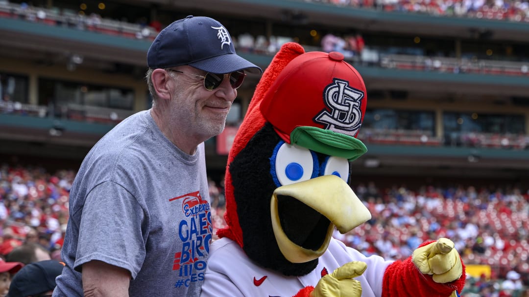 Jul 14, 2024; St. Louis, Missouri, USA; American actor J.K. Simmons poses for a photo with St. Louis Cardinals mascot Fredbird during the eighth inning of a game against the Chicago Cubs at Busch Stadium.