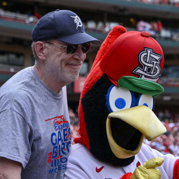 Jul 14, 2024; St. Louis, Missouri, USA; American actor J.K. Simmons poses for a photo with St. Louis Cardinals mascot Fredbird during the eighth inning of a game against the Chicago Cubs at Busch Stadium.