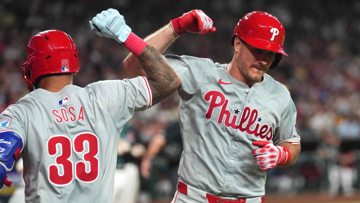 Aug 8, 2024; Phoenix, Arizona, USA; Philadelphia Phillies catcher J.T. Realmuto (10) celebrates with Philadelphia Phillies shortstop Edmundo Sosa (33) after hitting a solo home run against the Arizona Diamondbacks during the seventh inning at Chase Field. Mandatory Credit: Joe Camporeale-USA TODAY Sports