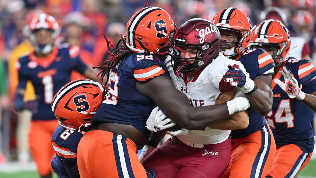Sep 12, 2025; Syracuse, New York, USA; Colgate Raiders tight end Mason Mozo (87) is tackled by Syracuse Orange defensive lineman Rashard Perry (92) and others in the third quarter at the JMA Wireless Dome. Mandatory Credit: Mark Konezny-Imagn Images Sep 12, 2025; Syracuse, New York, USA; Colgate Raiders tight end Mason Mozo (87) is tackled by Syracuse Orange defensive lineman Rashard Perry (92) and others in the third quarter at the JMA Wireless Dome. Mandatory Credit: Mark Konezny-Imagn Images