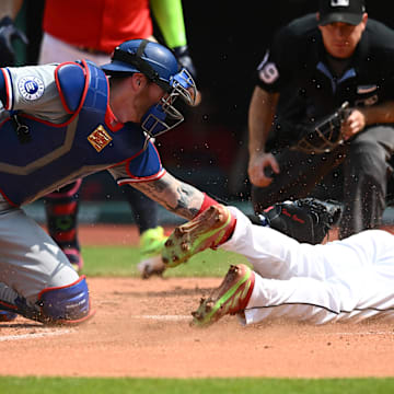 Aug 25, 2024; Cleveland, Ohio, USA; Cleveland Guardians third baseman Jose Ramirez (11) is tagged out at home by Texas Rangers catcher Jonah Heim (28) during the third at Progressive Field. 