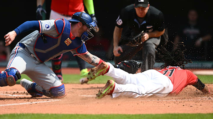 Aug 25, 2024; Cleveland, Ohio, USA; Cleveland Guardians third baseman Jose Ramirez (11) is tagged out at home by Texas Rangers catcher Jonah Heim (28) during the third at Progressive Field. 