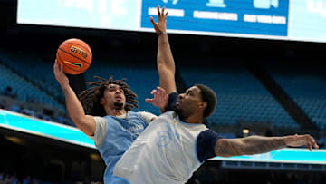 Oct 12, 2024; Chapel Hill, NC, USA;  North Carolina Tar Heels guard Elliot Cadeau (3) shoots as forward Ty Claude (0) defends in the first half at the Dean E. Smith Center. Mandatory Credit: Bob Donnan-Imagn Images