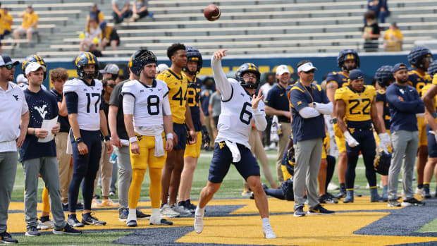 West Virginia University senior quarterback Garrett Greene launches a pass during a 1v1 drilling the Gold-Blue Spring Game.