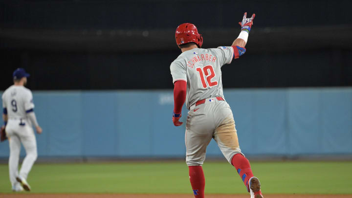 Aug 7, 2024; Los Angeles, California, USA;  Philadelphia Phillies designated hitter Kyle Schwarber (12) rounds the bases after a three-run home run in the sixth inning against the Los Angeles Dodgers at Dodger Stadium.