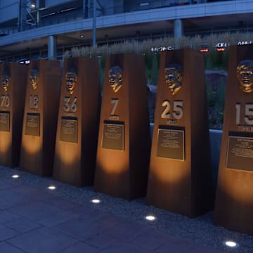 Aug 20, 2014; Denver, CO, USA; General view of the historical monument pillars of former Denver Broncos players at Sports Authority Field at Mile High. From left: Floyd Little (44), Austin Gonsoulin (Goose Gonsoulin), Lionel Taylor (87), Gerald H. Phipps and Charley Johnson (12), Paul Smith (70), Frank Tripucka (18), Billy Thompson (36), Craig Morton (7), Haven Moses (25) and Jim Turner (15). 