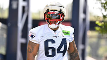 Jul 23, 2025; Foxborough, MA, USA; New England Patriots guard Layden Robinson (64) walks to the practice field for training camp at Gillette Stadium.