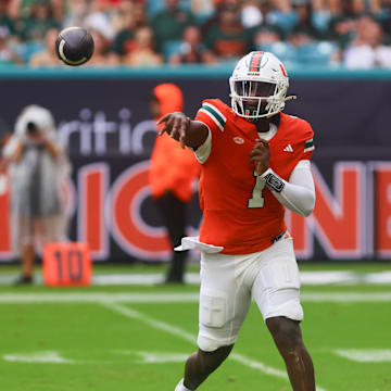 Sep 14, 2024; Miami Gardens, Florida, USA;  Miami Hurricanes quarterback Cam Ward (1) passes the football against the Ball State Cardinals during the first quarter at Hard Rock Stadium. Mandatory Credit: Sam Navarro-Imagn Images